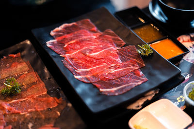 High angle view of meat on barbecue grill