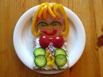 High angle view of woman made from sandwich on table