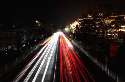 High angle view of light trails on road at night