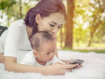 Mother and daughter while using smart phone