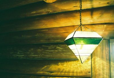 Close-up of illuminated lamp against sky