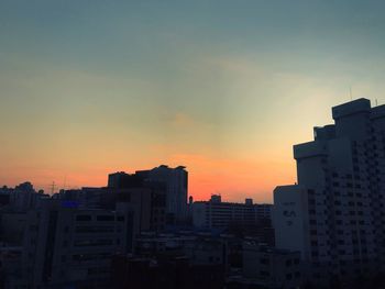 Cityscape against sky during sunset