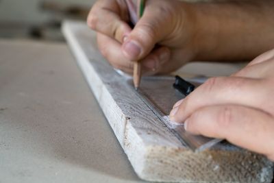 Midsection of person working on wood