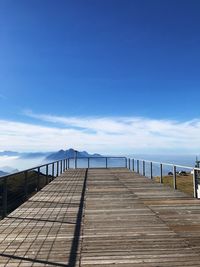 Pier against blue sky during sunny day
