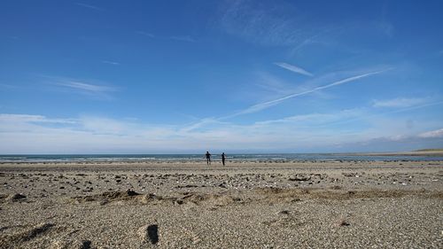Scenic view of beach against blue sky