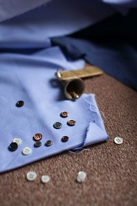 High angle view of buttons on fabric
