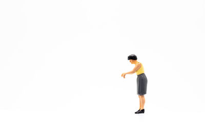 Full length of woman standing against white background