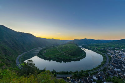 Scenic view of landscape against clear sky during sunset
