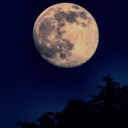 Low angle view of moon against clear sky at night