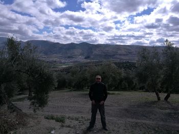 Full length of man standing on road against sky