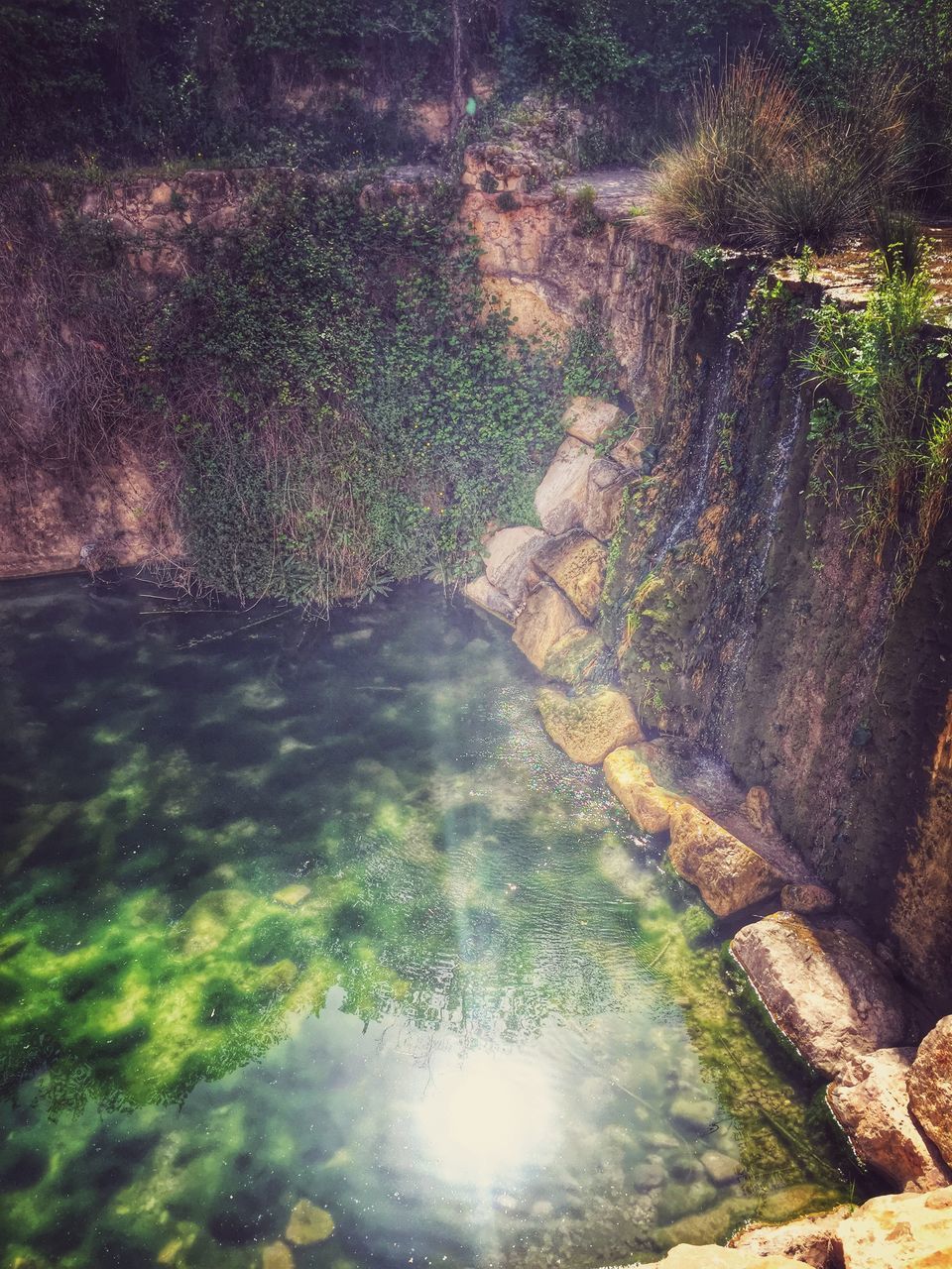 water, reflection, puddle, nature, sunlight, wet, rock - object, high angle view, motion, beauty in nature, stream, flowing water, waterfront, tranquility, outdoors, day, splashing, no people, river, scenics