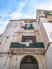 Low angle view of building against cloudy sky