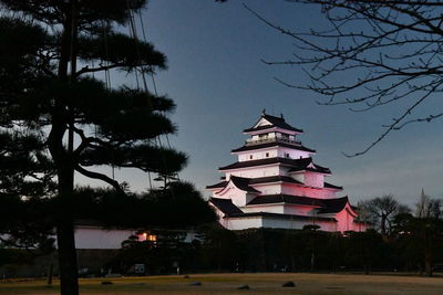 Low angle view of silhouette building against sky at dusk