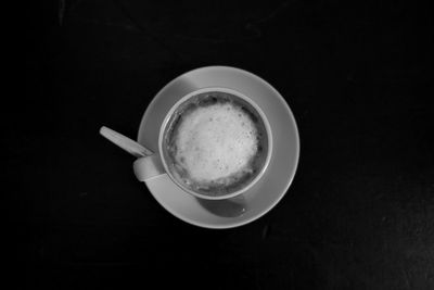 Directly above shot of coffee cup on black background