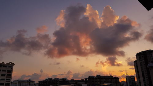 Low angle view of cityscape against sky during sunset