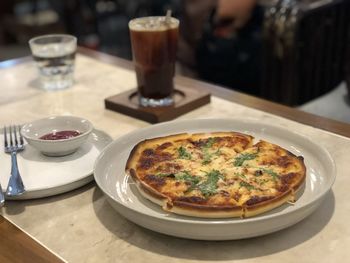 High angle view of pizza served on table