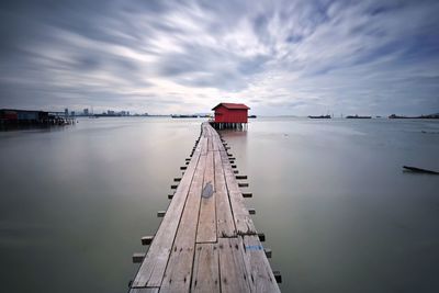 Pier over lake against sky