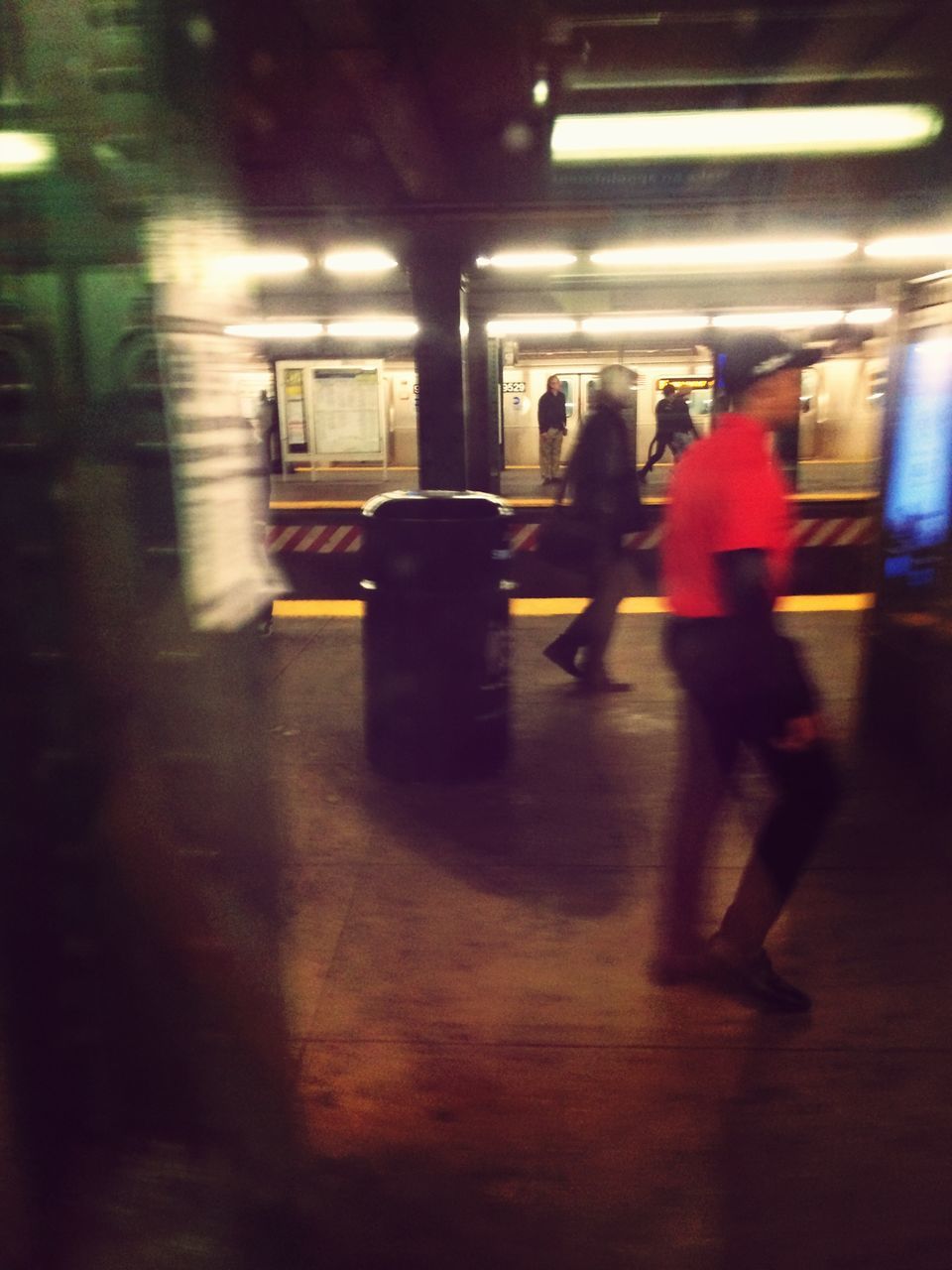 indoors, transportation, men, lifestyles, walking, mode of transport, person, illuminated, public transportation, travel, full length, on the move, rear view, blurred motion, passenger, city life, leisure activity, railroad station platform, railroad station