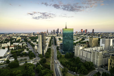 Warsaw, city centre panorama at sunset, business centre 2022. sunset reflected in buildings.