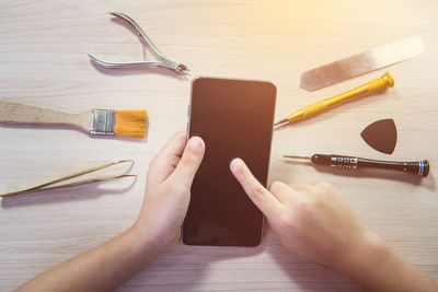 Close-up of hands on table