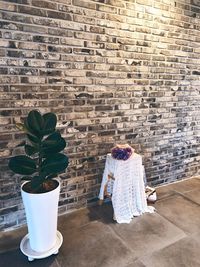 Rear view of woman standing against wall