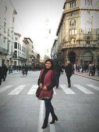 Woman standing on city street