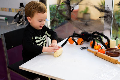 Portrait of boy sitting on table