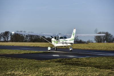 Airplane on runway against clear sky