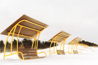 Built structure on field against clear sky during winter