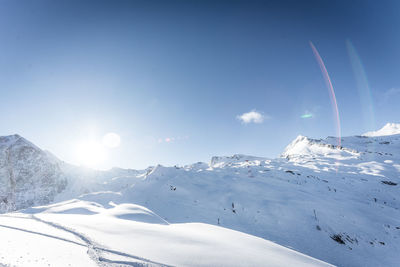 Scenic view of snowcapped mountains against sky