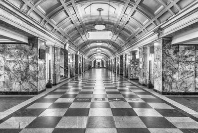 Empty corridor in illuminated subway station