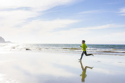 Boy running on a beach