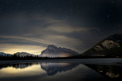 Rundle mountain reflected in vermillion lake at night