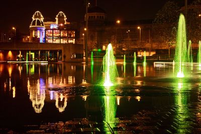 Reflection of illuminated buildings in water at night