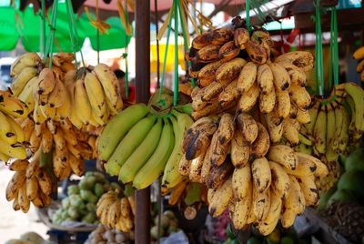 Close-up of fruits hanging at market stall