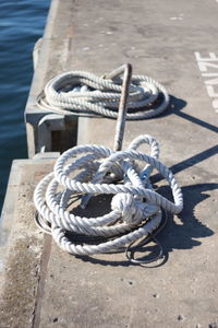 High angle view of rope tied on pier