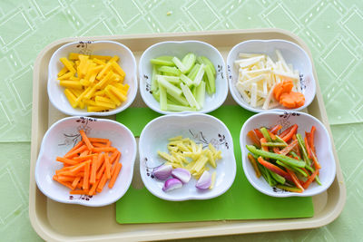 High angle view of vegetables in bowls on tray