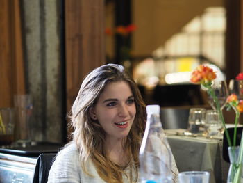 Portrait of smiling young woman at restaurant