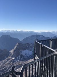 Scenic view of mountain range against blue sky