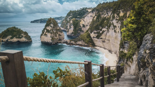 Scenic view of sea and mountains against sky