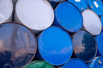 Old chemical barrels. blue, white, and green oil drum. steel oil tank. toxic waste warehouse. 