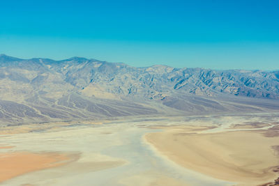 Scenic view of dramatic landscape against clear blue sky