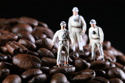 Close-up of statues on table against black background