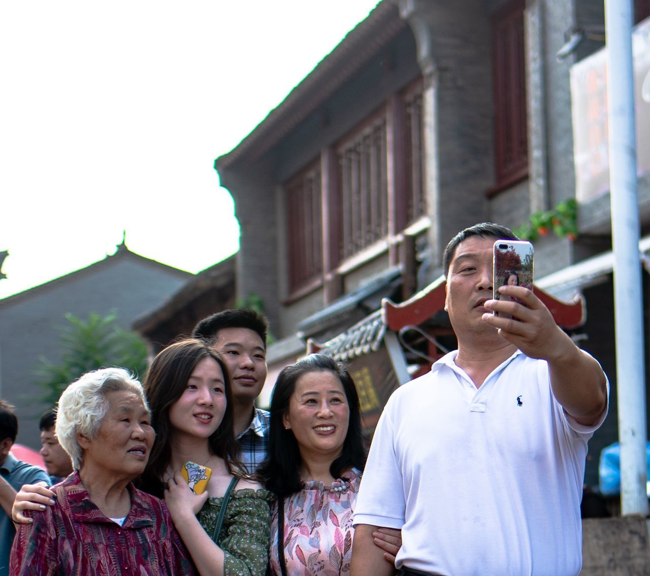 group of people, architecture, real people, building exterior, women, built structure, lifestyles, smiling, portrait, front view, emotion, young adult, men, togetherness, happiness, standing, adult, people, leisure activity, outdoors, mature men