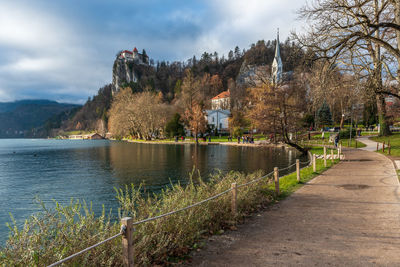 River amidst trees and buildings against sky