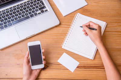 High angle view of person using laptop on table