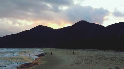 Silhouette of tourists on beach