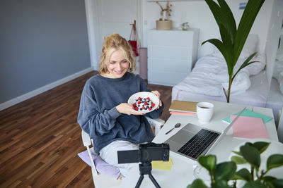 Portrait of cute girl using laptop at home