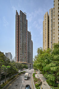 Street amidst buildings against sky in city