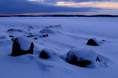 Scenic view of frozen sea against sky during winter